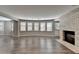 Finished basement featuring a brick fireplace, wood flooring, and many windows for natural light at 3237 Birkdale Ave, Duluth, GA 30097