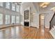 Bright living room with hardwood floors, stone fireplace, built-in bookshelves, and large windows at 3237 Birkdale Ave, Duluth, GA 30097