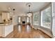 Open-concept living room with hardwood floors, fireplace, and natural light from large windows at 3237 Birkdale Ave, Duluth, GA 30097