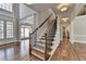 Staircase with hardwood floors, open floor plan, arched doorway and lots of natural light at 3237 Birkdale Ave, Duluth, GA 30097