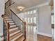 Elegant staircase with iron railing, hardwood treads and view to great room with large windows at 3237 Birkdale Ave, Duluth, GA 30097