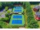 A picturesque tennis facility boasts multiple blue courts and is surrounded by lush greenery and trees at 3237 Birkdale Ave, Duluth, GA 30097