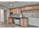 Wet bar with wood cabinets, granite countertop, wine rack, tile backsplash and stainless dishwasher at 3237 Birkdale Ave, Duluth, GA 30097