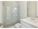Bathroom with glass-enclosed shower, granite countertop sink, and modern fixtures at 5827 Creek Indian Dr, Sugar Hill, GA 30518