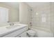 Bright bathroom with a single sink, vanity, tiled shower/tub and modern finishes at 5827 Creek Indian Dr, Sugar Hill, GA 30518