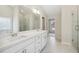 Bright bathroom features a double sink vanity with modern white cabinets and a luxurious walk-in shower at 5827 Creek Indian Dr, Sugar Hill, GA 30518