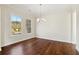 Well-lit dining area with hardwood floors and large windows at 5827 Creek Indian Dr, Sugar Hill, GA 30518