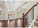 Inviting foyer with hardwood floors, staircase, and ample natural light at 5827 Creek Indian Dr, Sugar Hill, GA 30518