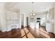 Modern kitchen with white cabinetry, hardwood floors and built-in desk at 5827 Creek Indian Dr, Sugar Hill, GA 30518