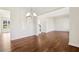 Open-concept living space with hardwood floors and modern lighting at 5827 Creek Indian Dr, Sugar Hill, GA 30518
