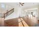 Spacious living room with hardwood floors, staircase, and open kitchen access at 5827 Creek Indian Dr, Sugar Hill, GA 30518