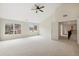 Expansive main bedroom features a vaulted ceiling, plush carpeting and a view of the yard at 5827 Creek Indian Dr, Sugar Hill, GA 30518
