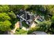 Stunning aerial view of a two-story home featuring a backyard pool, patio, and circular driveway at 725 Riley Pl, Atlanta, GA 30327