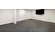 Spacious basement area, featuring a large TV and a minimalist design, creating a modern and comfortable atmosphere at 725 Riley Pl, Atlanta, GA 30327