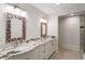 Bathroom featuring double sinks with granite countertop and decorative framed mirrors, enhancing its aesthetic appeal at 725 Riley Pl, Atlanta, GA 30327