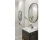 Elegant bathroom with oval mirror and decorative vanity at 725 Riley Pl, Atlanta, GA 30327
