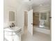 Bathroom with a marble vanity, tiled floors, and a shower tub with glass doors at 725 Riley Pl, Atlanta, GA 30327