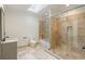 Bright bathroom featuring travertine tiling, a glass shower, and a skylight at 725 Riley Pl, Atlanta, GA 30327