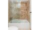 Bathroom tub with a shower, decorative tile, and sliding glass doors at 725 Riley Pl, Atlanta, GA 30327