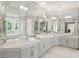 Bright, spacious bathroom featuring dual sinks, seamless mirrors, and natural light at 725 Riley Pl, Atlanta, GA 30327