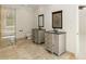 Elegant bathroom featuring dual vanities, tiled floors, and a glass-enclosed walk-in shower at 725 Riley Pl, Atlanta, GA 30327