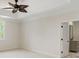Neutral bedroom featuring an elegant ceiling fan, neutral walls, and access to an ensuite bathroom at 725 Riley Pl, Atlanta, GA 30327