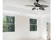 Bright bedroom with white walls, large windows overlooking trees, and a modern ceiling fan at 725 Riley Pl, Atlanta, GA 30327