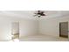 Neutral bedroom featuring a modern ceiling fan, neutral walls, and adjoining rooms at 725 Riley Pl, Atlanta, GA 30327