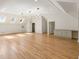 Spacious bonus room featuring hardwood floors, white walls, and modern light fixtures at 725 Riley Pl, Atlanta, GA 30327