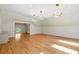 Spacious bonus room featuring hardwood floors and modern pendant lighting fixtures at 725 Riley Pl, Atlanta, GA 30327