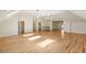 Expansive bonus room featuring hardwood floors and modern pendant lighting fixtures at 725 Riley Pl, Atlanta, GA 30327