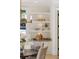 Cozy dining area showcasing built-in shelving, a chandelier, and natural light from the window at 725 Riley Pl, Atlanta, GA 30327