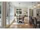 Bright dining area with hardwood floors, modern lighting, and large windows overlooking the yard at 725 Riley Pl, Atlanta, GA 30327