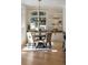 Bright dining area featuring a round table, four chairs, a large window, and built-in shelves at 725 Riley Pl, Atlanta, GA 30327