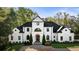 Stately home with circular driveway, manicured front lawn, and elegant landscaping, creating a grand entrance at 725 Riley Pl, Atlanta, GA 30327