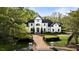 Estate home with circular driveway, elegant landscaping, and dark trim windows, enhancing curb appeal at 725 Riley Pl, Atlanta, GA 30327