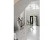 Elegant foyer with a crystal chandelier, marble flooring, and a curved staircase, showcasing luxurious details at 725 Riley Pl, Atlanta, GA 30327