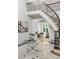 Bright foyer with a curved staircase and wrought iron railing, with an open view to the formal living room at 725 Riley Pl, Atlanta, GA 30327