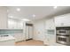 Well-lit kitchen featuring white cabinets and stainless steel appliances at 725 Riley Pl, Atlanta, GA 30327