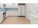 Bright kitchen with white cabinets, stainless steel appliances, and light backsplash at 725 Riley Pl, Atlanta, GA 30327