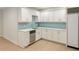 Modern kitchen with white cabinets, stainless steel appliances, and marble countertops at 725 Riley Pl, Atlanta, GA 30327