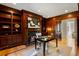 Cozy home library with wood paneled walls, fireplace, and custom built-in shelving at 725 Riley Pl, Atlanta, GA 30327