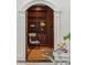 Open arched doorway from living room into library with custom built-in wood shelves at 725 Riley Pl, Atlanta, GA 30327