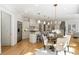 Open-concept living area with stainless steel appliances, white cabinets, and hardwood floors at 725 Riley Pl, Atlanta, GA 30327