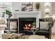 Living room featuring a cozy fireplace flanked by black leather chairs, and built in cabinets at 725 Riley Pl, Atlanta, GA 30327
