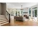 Cozy living room featuring a fireplace, hardwood floors, and ample natural light from large windows at 725 Riley Pl, Atlanta, GA 30327