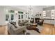Sophisticated living room with hardwood floors, fireplace, wet bar, and large windows to an outdoor patio at 725 Riley Pl, Atlanta, GA 30327