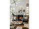 Living room featuring a cozy fireplace flanked by black leather chairs, and built in cabinets at 725 Riley Pl, Atlanta, GA 30327