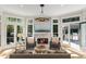 Bright living room featuring a fireplace, comfortable seating, and access to outdoor patio at 725 Riley Pl, Atlanta, GA 30327