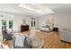 Bright main bedroom with ensuite, sitting area, balcony access, and tray ceilings at 725 Riley Pl, Atlanta, GA 30327